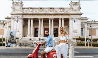 A couple on a scooter in front of the Galleria Nazionale in Rome.