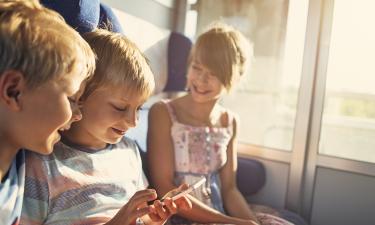 Children seated together on a train. 